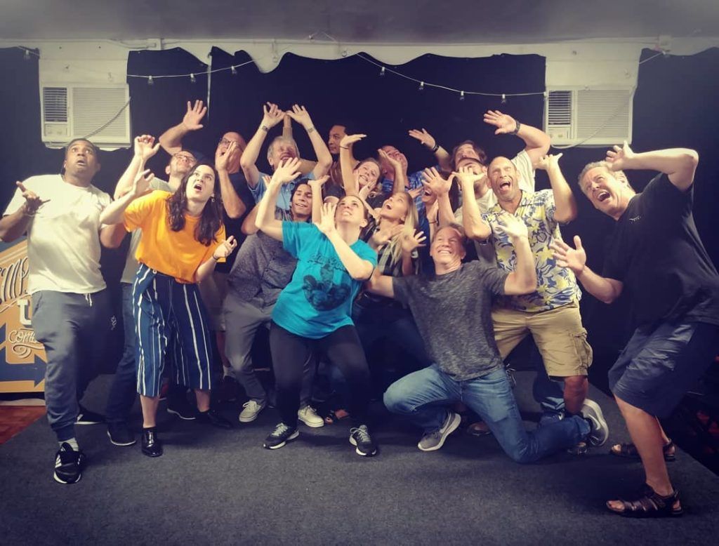A group striking dramatic poses on stage