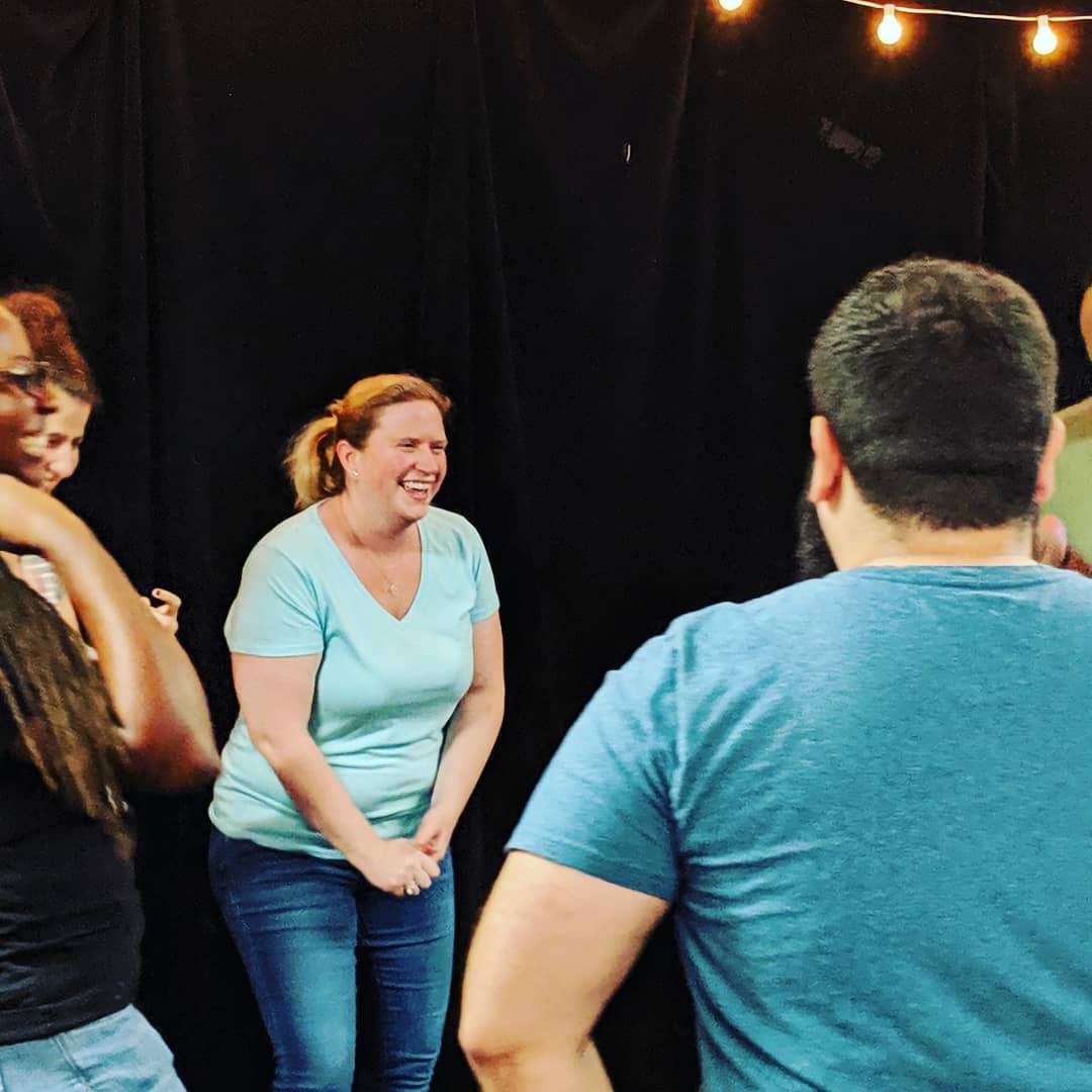 A participant laughing during an improv exercise