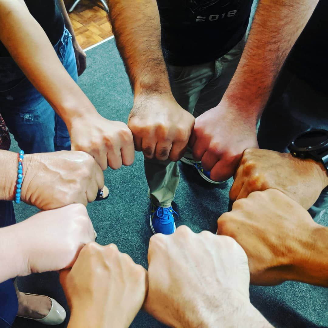 A circle of fists coming together