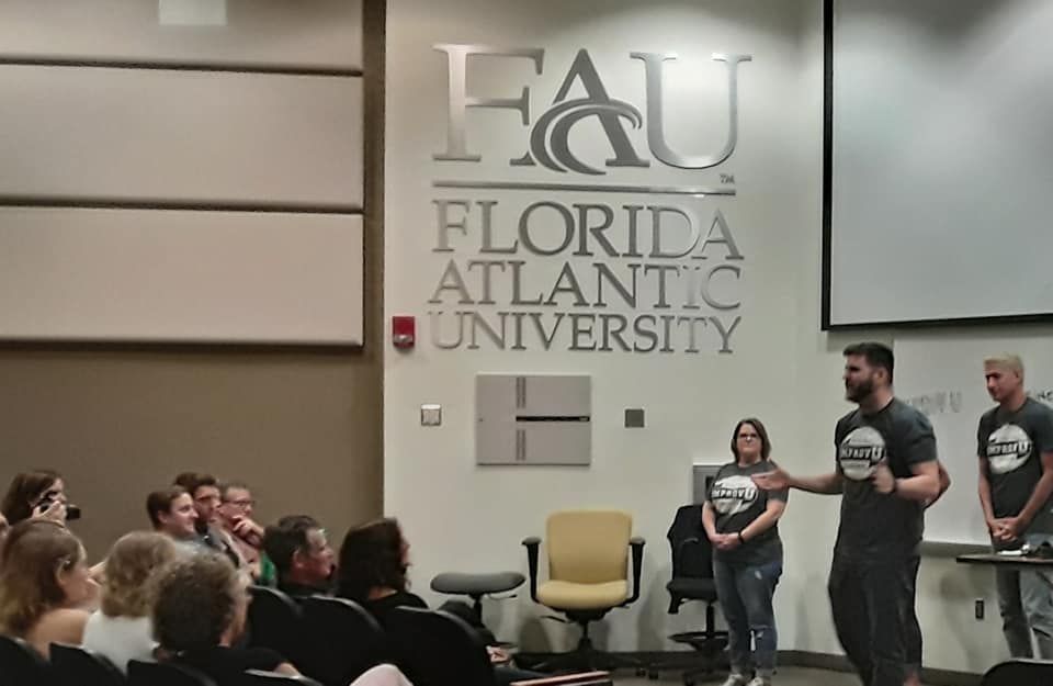 Improv U facilitators presenting in a university lecture hall