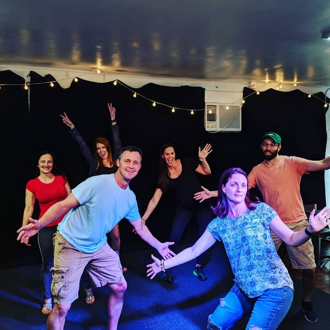 Participants striking playful poses on stage