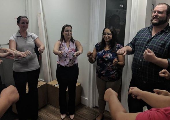 Coworkers linking hands during an exercise